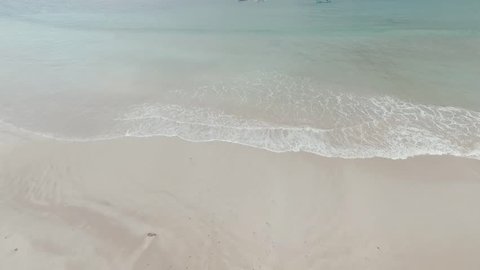 Clear water and soft wave on sand beach for opening video, text space. white sand beach