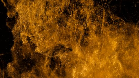 Golden ink in water shooting with high speed camera. ?opper drops of paint dropped, reacting, creating abstract cloud formations metamorphosis on black. Art backgrounds.