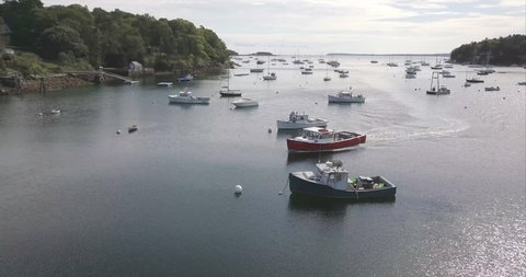 Rockport, Maine / United States - 09 22 2017: ROCKPORT, MAINE, SEPTEMBER 2017 - A red commercial boat coming in to port in Rockport Harbor.