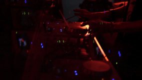 DJ mixing club music, using control deck, music video background
