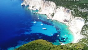 Aerial drone bird's eye view video of tropical rocky arch with turquoise clear waters in iconic island of Paxos, Ionian, Greece