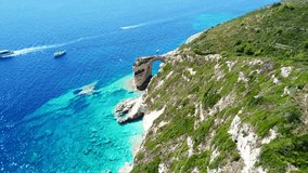 Aerial drone bird's eye view video of tropical rocky arch of Tripitos with turquoise clear waters in iconic island of Paxos, Ionian, Greece