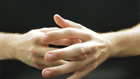 Close Up Of Man Hands Cracking Knuckles with black background