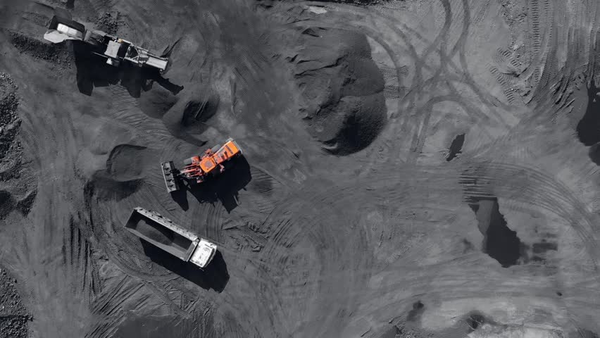 Above mine. Open Pit mine industry, big Yellow Mining Truck for Coal, Top view Aerial Drone.