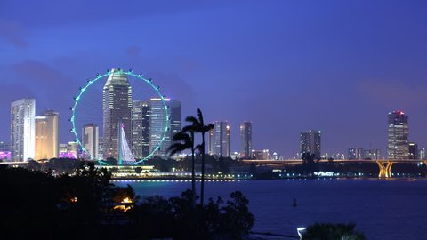 SINGAPORE, SINGAPORE - APRIL 12, 2011 Time Lapse Aerial View of Famous Singapore Flyer and City Skyline Dusk to Night