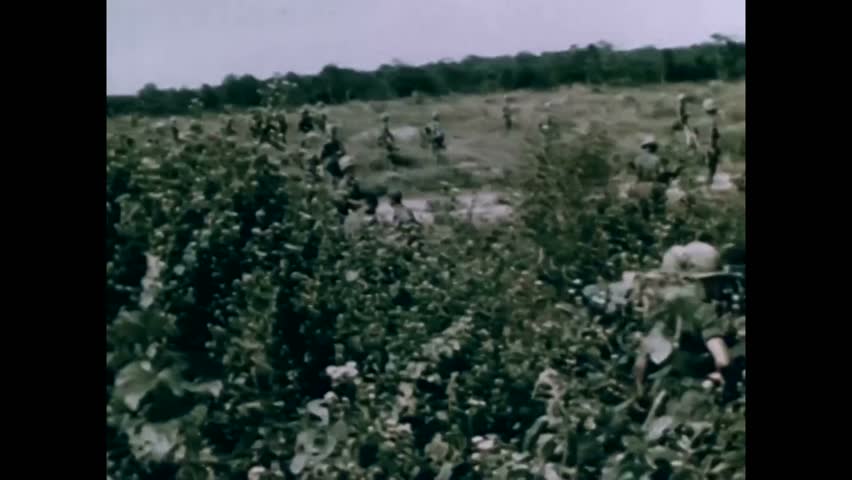 CIRCA 1965 - American soldiers in Vietnam fire mortar rounds to cut off Viet Cong snipers.