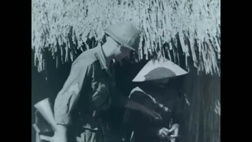 CIRCA 1965 - American soldiers find Vietnam villagers suspected of being Viet Cong, and bind and blindfold them to take them for interrogation.