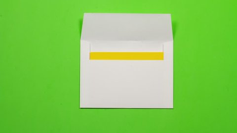 yellow sheet of paper folds and gets into a white envelope. Then leaves screen on the right. seamless loop. With alpha channel  luma matte to add copy and remove background.