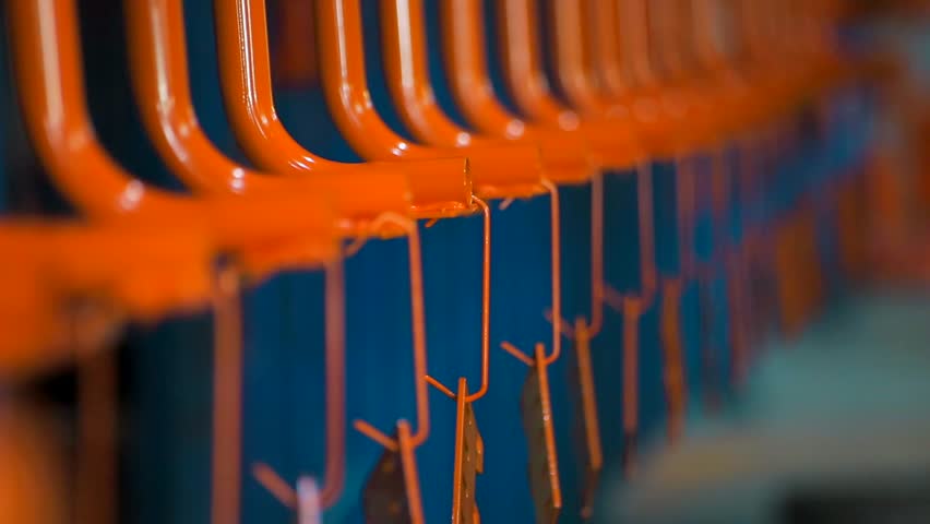 painted parts leave the paint shop. New orange parts weigh on the conveyor. Many items are on the plant. Orange color details. Painting Royalty-Free Stock Footage #1016329255