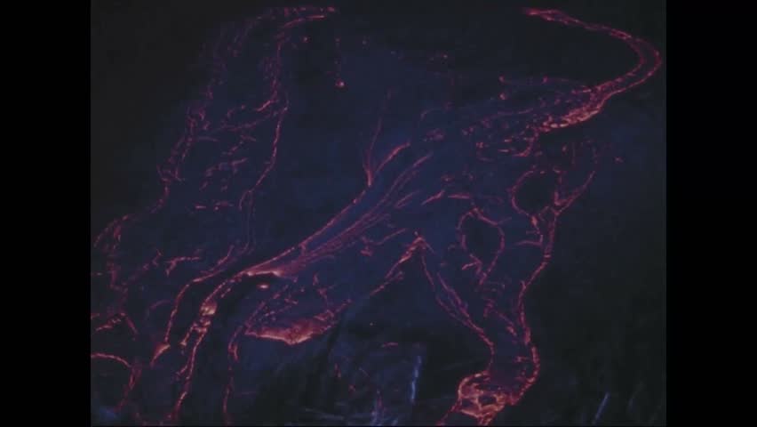 CIRCA 1973 - Lava bubbles, pours, and pools in the Pauahi Crater at night.