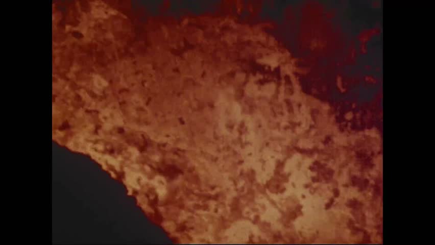 CIRCA 1973 - Close-ups show lava frothing and splashing through the Pauahi Crater at nighttime.