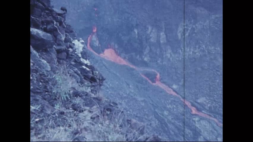 CIRCA 1973 - Lava darkens as it hardens, pooling through crevices in the Pauahi Crater.