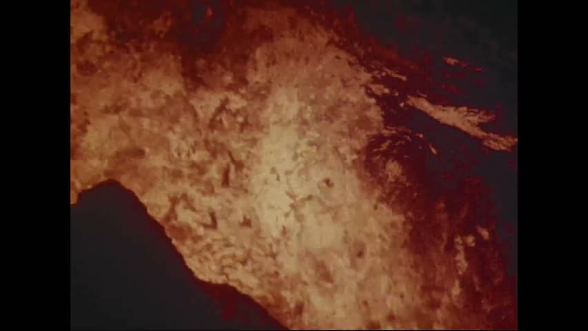 CIRCA 1973 - Lava bubbles, pours, and pools in the Pauahi Crater at night.
