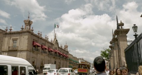 MORELIA, MEXICO - CIRCA AUGUST 2018 - Mexican flag flying above the historic buildings along The Avenida Francisco I. Madero which is the main tourist artery