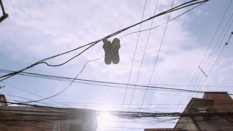 Sneakers on Electric Cable Telephone Wire Slow Motion