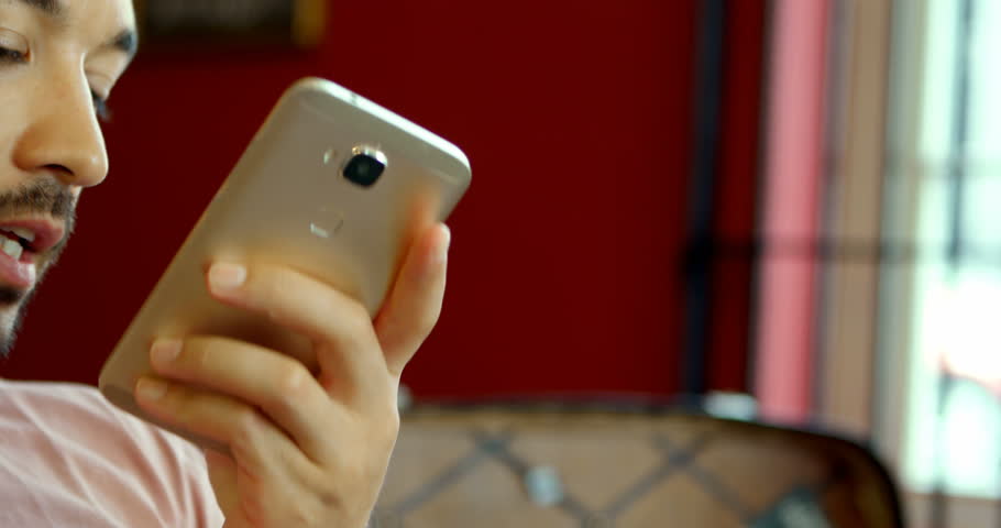 Man talking on mobile phone at barbershop 4k
