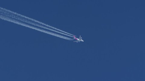 Contrails of a  Qantas Boeing A 380 against a Clear Blue Sky