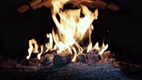 video footage stone fireplace with burning wood firewood / warming home atmosphere