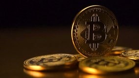 Bitcoin. Crypto currency Gold Bitcoin, BTC, Bit Coin. Macro shot of Bitcoin coins rotated on black background Blockchain technology, bitcoin mining concept. 4K UHD video