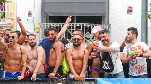 Torremolinos, Spain. June 2018. Group of men dancing in the parade of the Gay Pride. Slow motion.