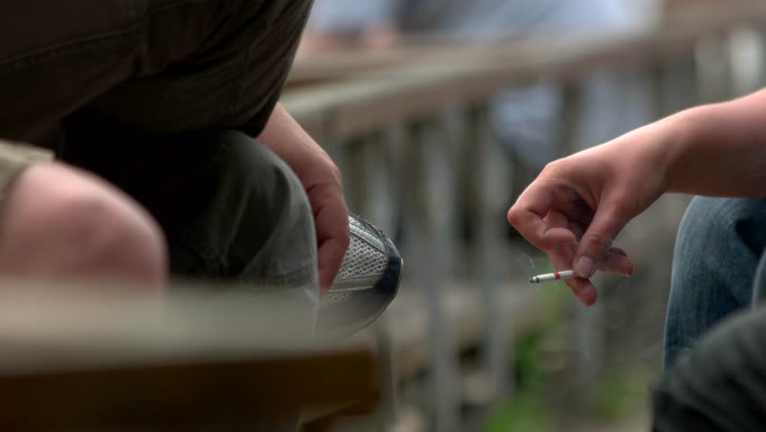 Hand holding a smoking cigarette. Smoking kills. Close up. Royalty-Free Stock Footage #1016368501