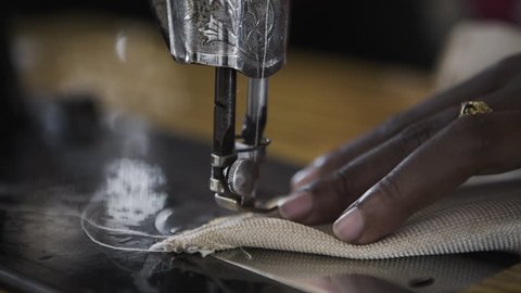 African Women Sewing with Mechanical Machine