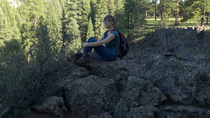 A young woman taking in the view on a canyon edge