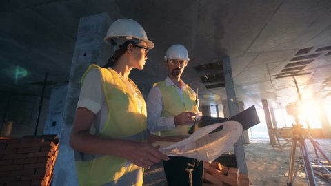 Workers, architects checking a building plan, close up.
