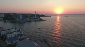 Summer. Evening. Sunset. Shooting from the air of  Sevastopol bay and Seaside boulevard, promenade, ships, ferry, monuments