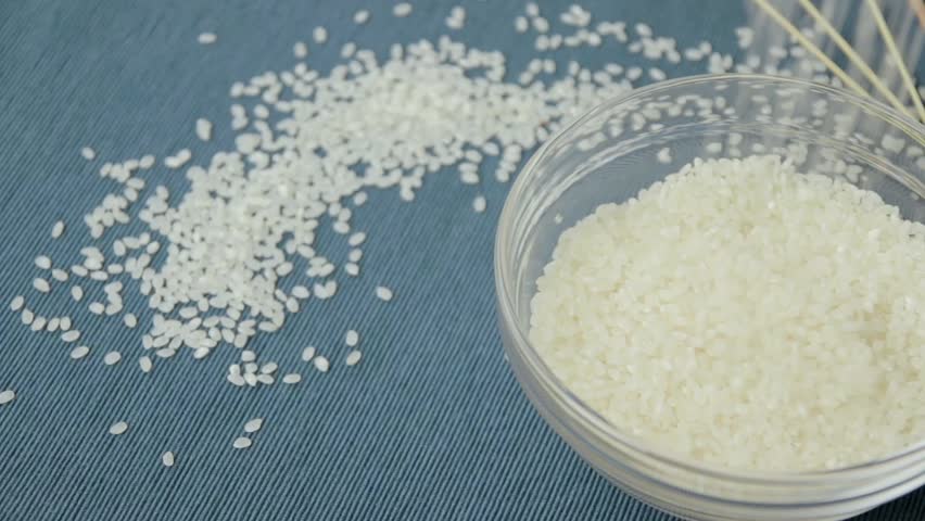 uncooked rice blue background Stock Footage Video (100% Royalty-free ...