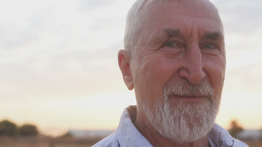 Senior man with a gray beard, sunset, field, concept of emotions. Senior man walking | Shutterstock HD Video #1016391169