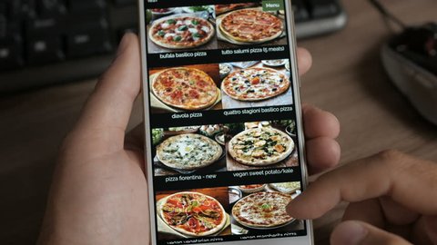 Man Orders Pizza Using Online Delivery Service With Smartphone. Close Up. 4K UHD.
