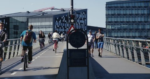 Copenhagen, Denmark - 23 August 2017: Bicycles and people walking on a bridge on a beautiful summer day 