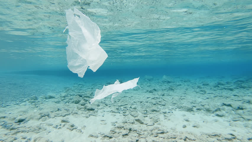 Sea Pollution by Plastic. Pieces Of Plastic Foil Floating Underwater Close To The Surface Royalty-Free Stock Footage #1016406004