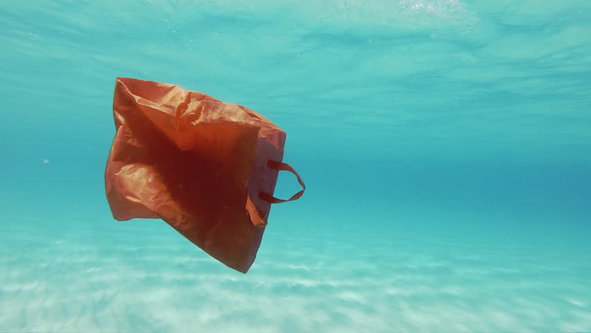 Plastic Pollution Underwater. Red Plastic Shopping Bag Floating Underwater In The Mediterranean Sea Royalty-Free Stock Footage #1016406277