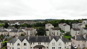 Aerial drone footage of suburban houses, field and bridges, South Queensferry, Scotland, United Kingdom.