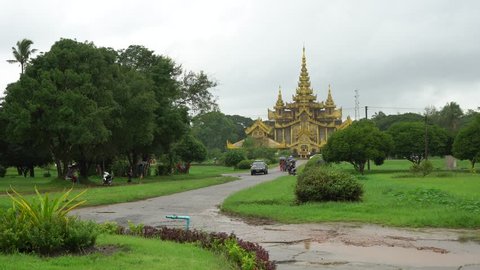 Bago, Myanmar - August 19,2018 : People in front of The Kambawzathardi Golden Palace (Palace of Bayinnaung) in Bago, Myanmar, in rainy day