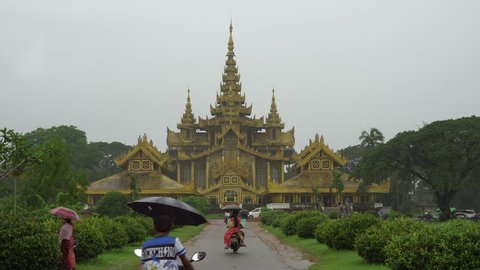 Bago, Myanmar - August 19,2018 : People in front of The Kambawzathardi Golden Palace (Palace of Bayinnaung) in Bago, Myanmar, in rainy day