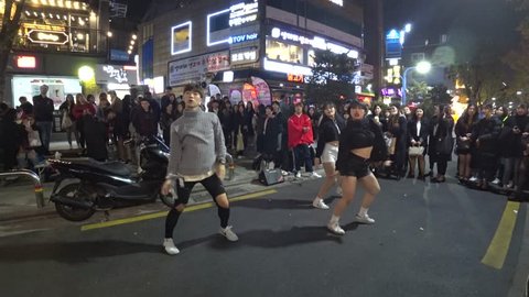 SEOUL,  KOREA - CIRCA NOVEMBER 2017 : Young STREET PERFORMER performing on the street at HONGDAE area.