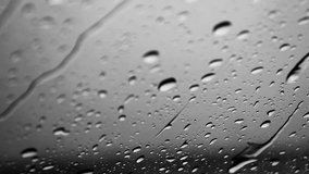 video of rain drops on a car mirror. Rain drops on a rainy day.