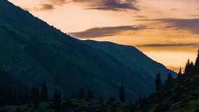 Kyrgyzstan forest on sunset. sky colors changing. pine trees on shadow. Central Asia landscape. time lapse video. Night shot, color cinema