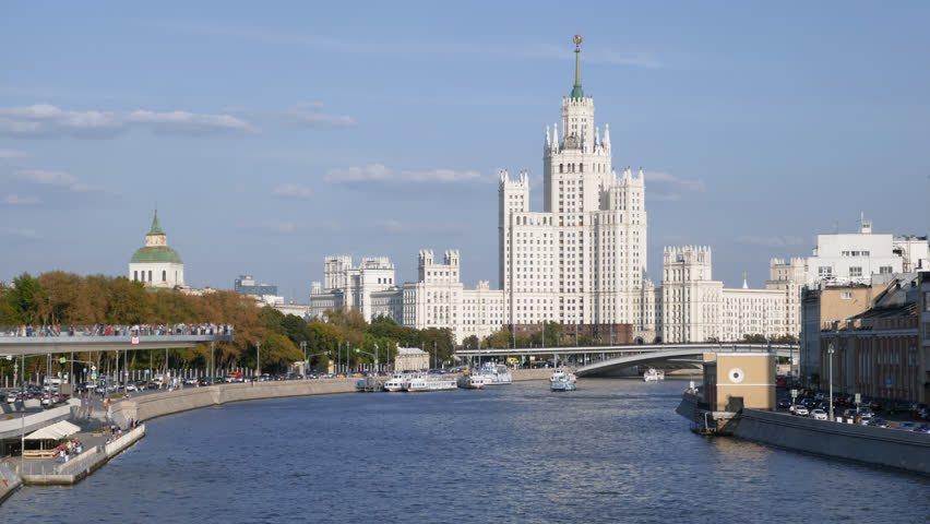 Time lapse of Moskva river with cruise ships, near the Kotelnicheskaya Embankment Building and Zaryadye Park, Moscow, Russia.