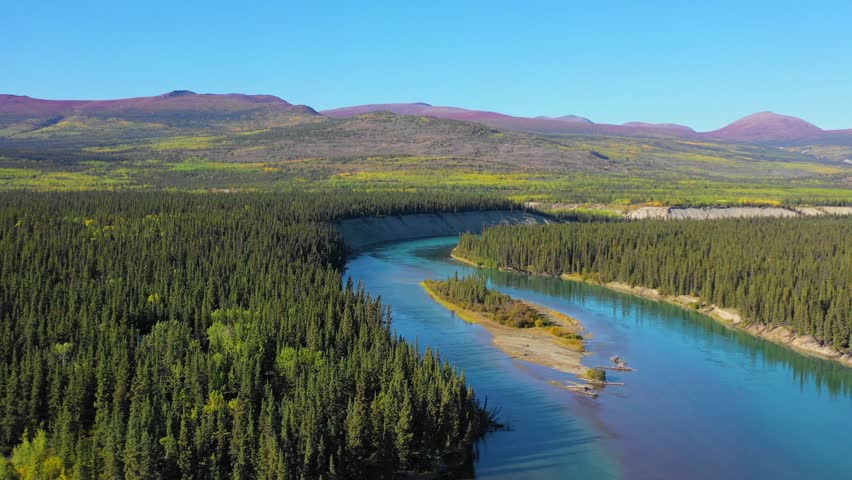 Flight over a small island at Mendenhall Landing on the way to Kusawa Lake, 5km from the Alaska Highway, on a sunny day in the Yukon in Canada. Royalty-Free Stock Footage #1016421496