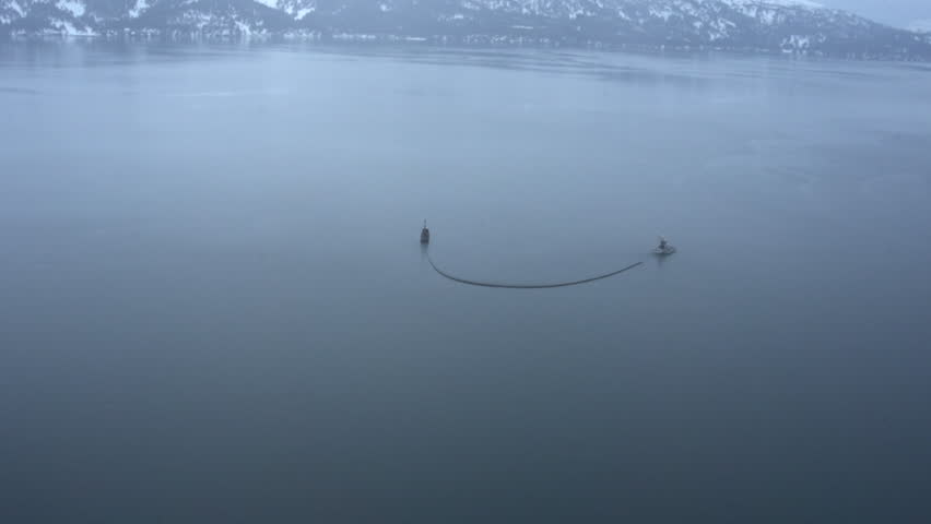 Two fishing boats pulling a boom in an oil spill training exercise,