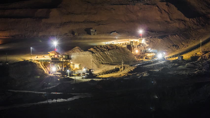 Time lapse Coal mining dump trucks and excavators working at night