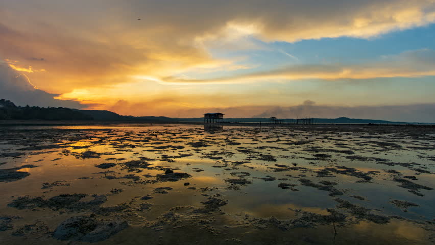 Beautiful sunset over sea with reflection in water, majestic clouds in the sky. Timelapse. 4k. 3840 X 2160. Photo JPEG. 