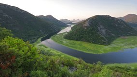Aerial view of Canyon of Rijeka Crnojevica river, Skadar lake lacation. Fantastic summer sunrise in Montenegro countryside. Beautiful world of Mediterranean countries. Full HD video (High Definition).