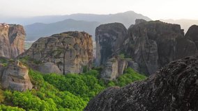 Splendid view of famous Eastern Orthodox monasteries listed as a World Heritage site, built on top of rock pillars. Beautiful spring sunset in Kalabaka location, Greece, Europe.  Full HD video.