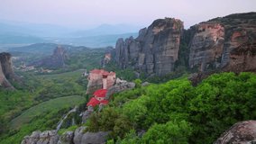 Majestic sunrise scene of famous Eastern Orthodox monasteries listed as a World Heritage site, built on top of rock pillars, Greece, Europe. Full HD video (High Definition).