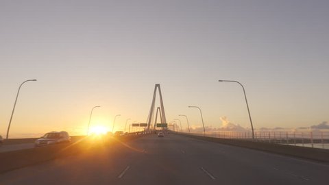 Driving on Arthur Ravenel Jr. Bridge at sunrise in Charleston SC. Driving on highway over bridge along the coast of South Carolina.